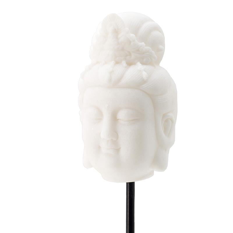 White stone bust of serene figure atop a black stand.