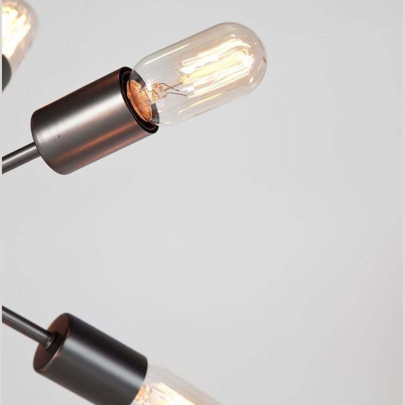 Close-up of a modern light bulb fixture, with a visible filament.