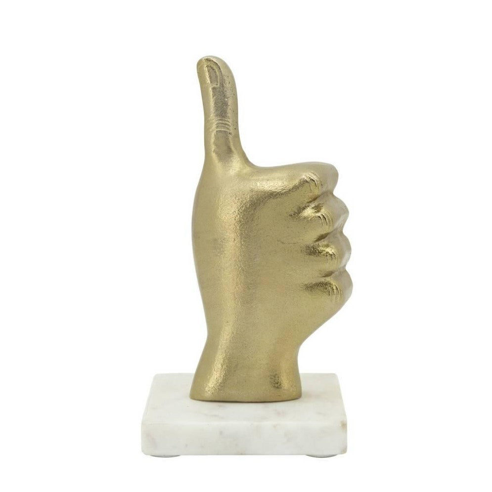Gold thumbs-up sculpture on a marble base.