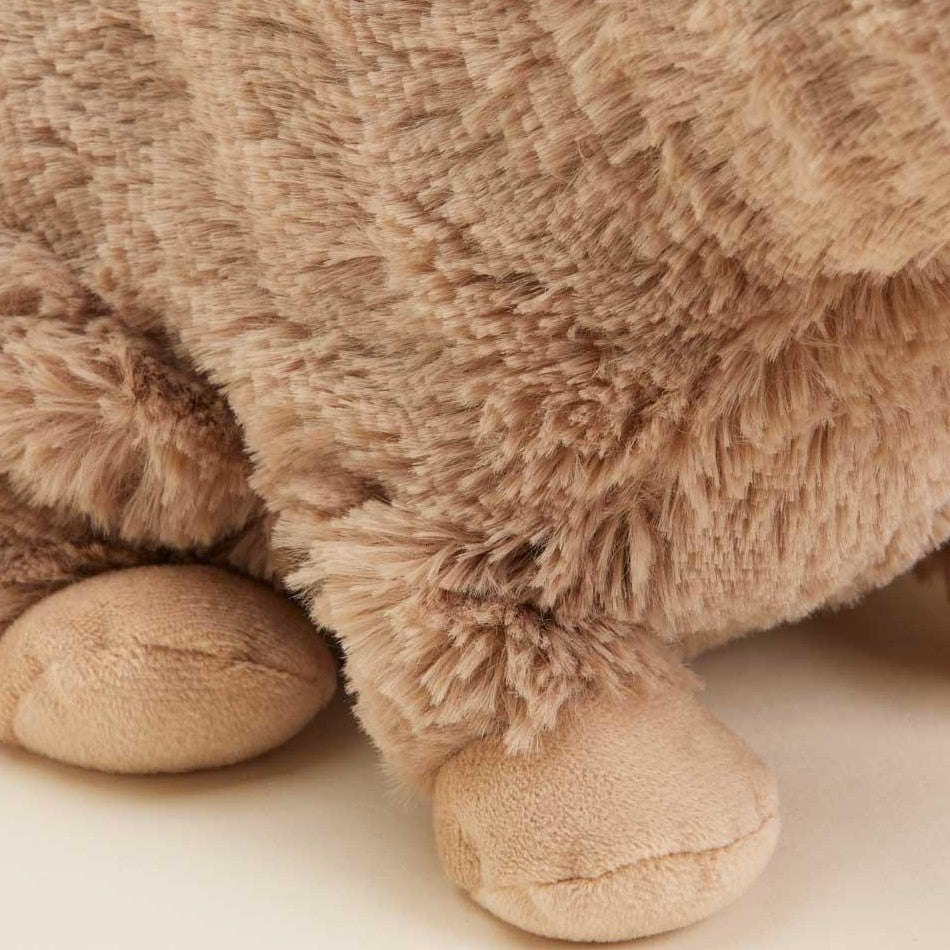 Close-up of brown plush toy with soft, fuzzy texture and round paws.