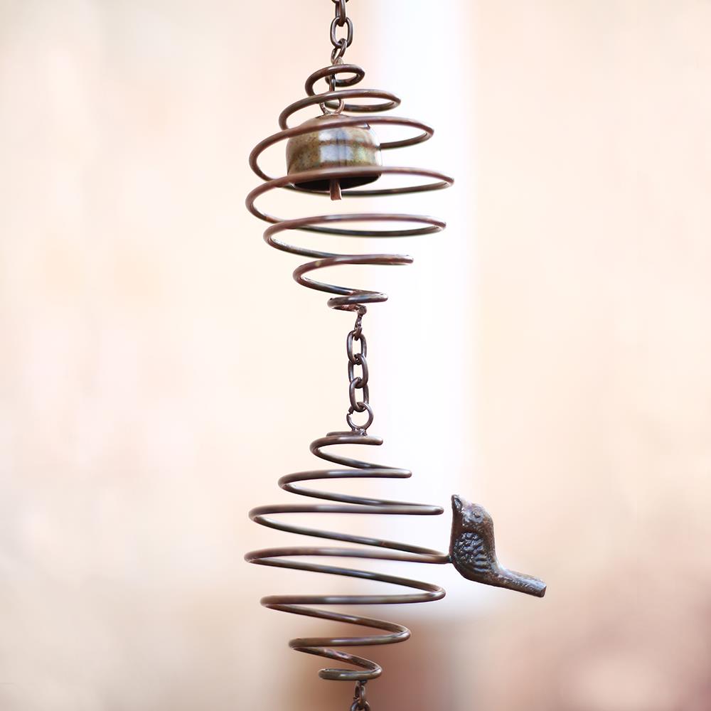 Spiral metal wind chime with bird and small bell detail.