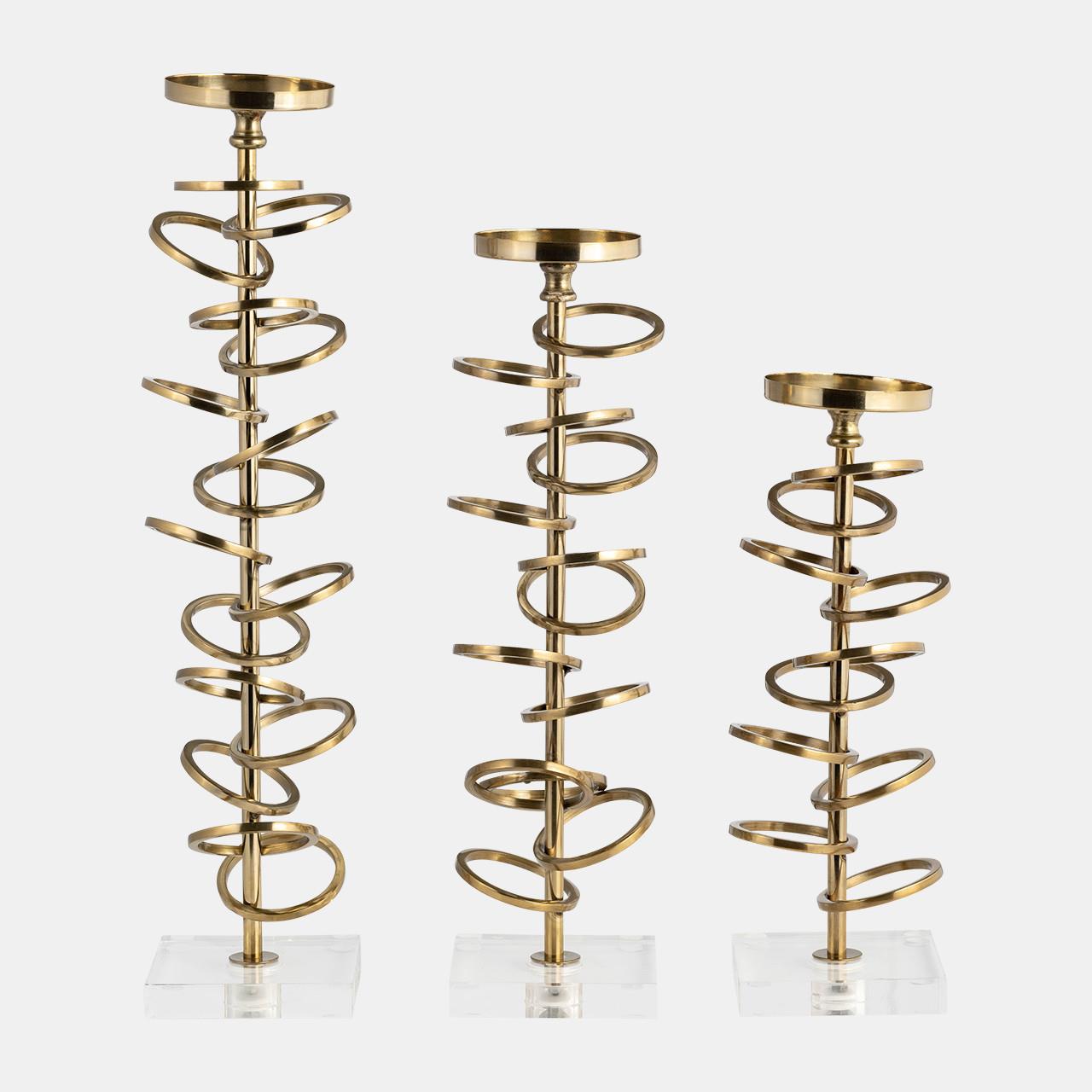 Three spiral gold candle holders on clear bases.