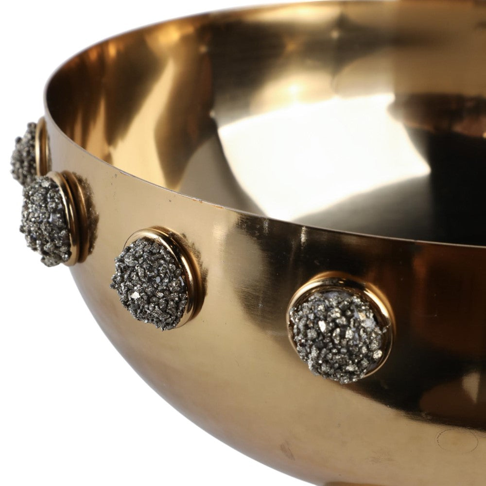 A metallic bowl adorned with textured, decorative studs.