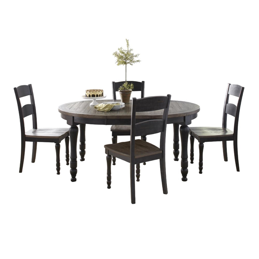 Round table with four chairs, cake, plates, and plant on top.