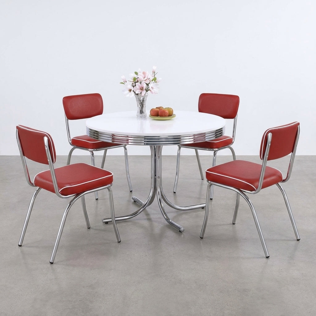 Retro dining set with red chairs and white table, flowers, and fruit centerpiece.