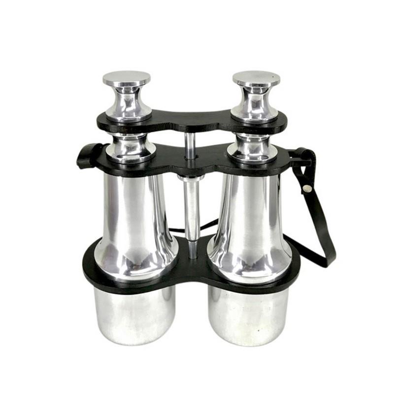 Shiny opera glasses with a black strap attached.