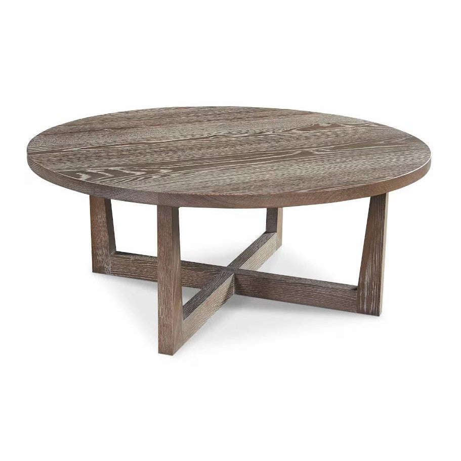 Round wooden coffee table with cross-shaped legs.