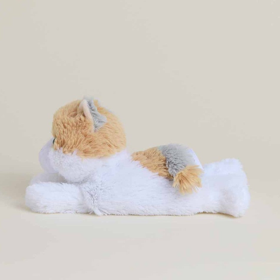 Plush toy dog lying on its stomach, side view.