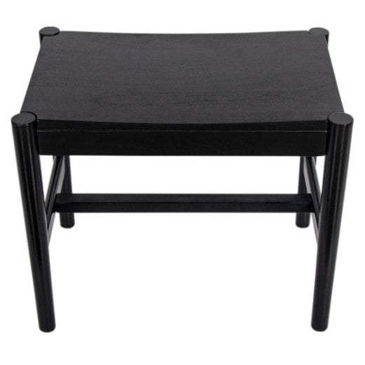 Black wooden stool with cylindrical legs and a rectangular seat.