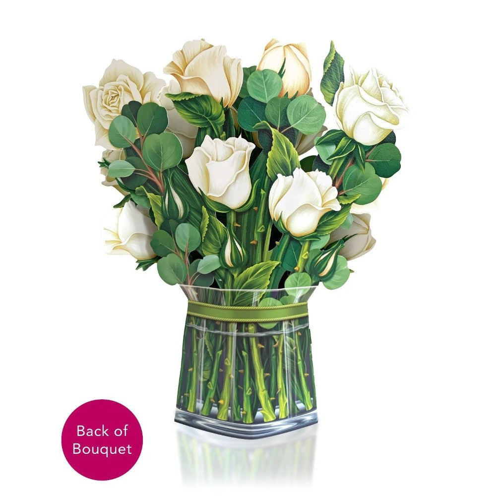 Bouquet of white roses and greenery in a vase.