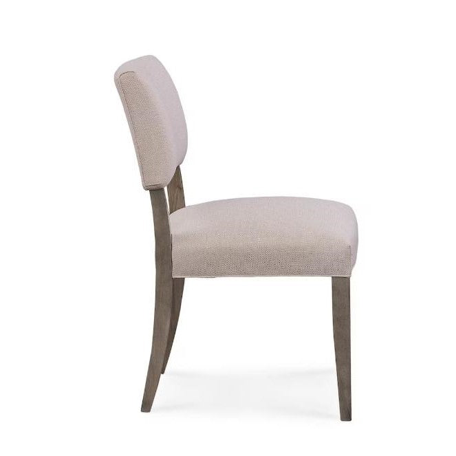 Modern beige upholstered chair, side view.