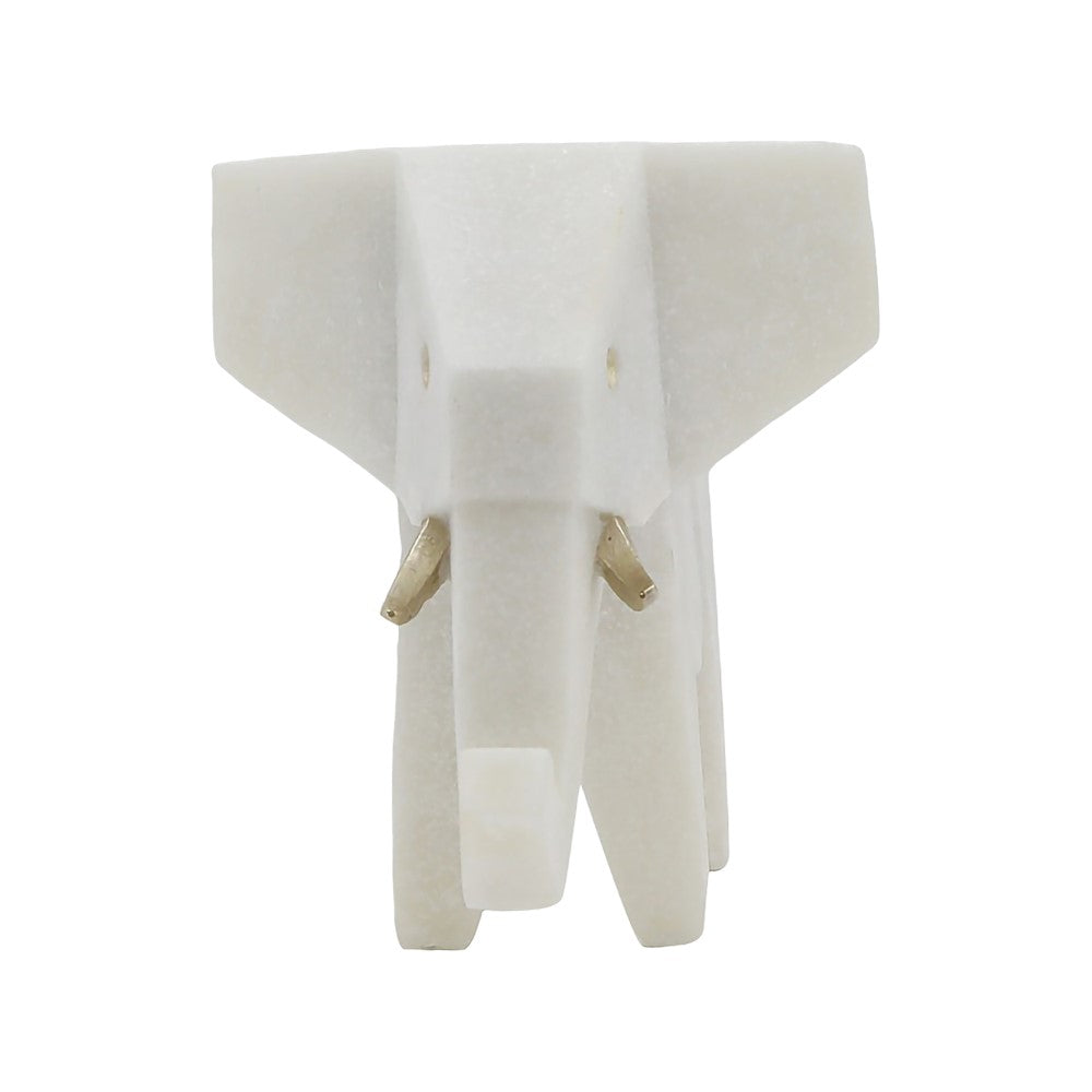 White geometric elephant sculpture with golden tusks.