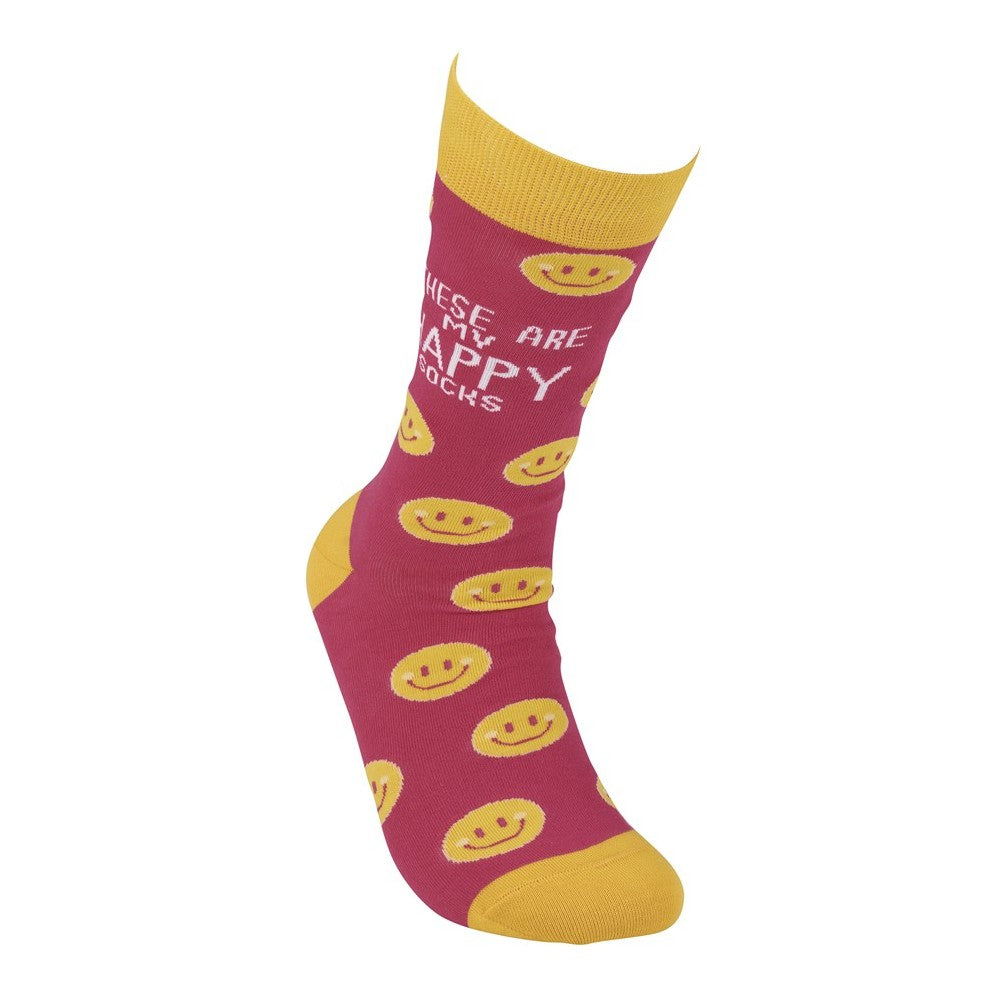 Red sock with yellow smiley faces and text: "These are my happy socks."