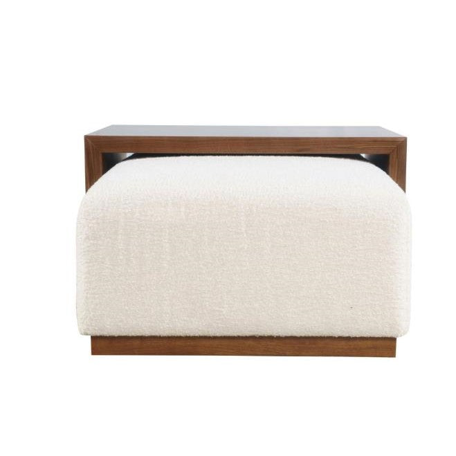 Modern bench with white cushioning and wooden frame.