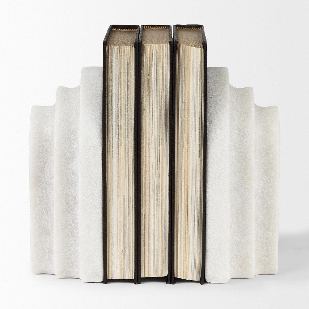 Three books standing upright between textured bookends.