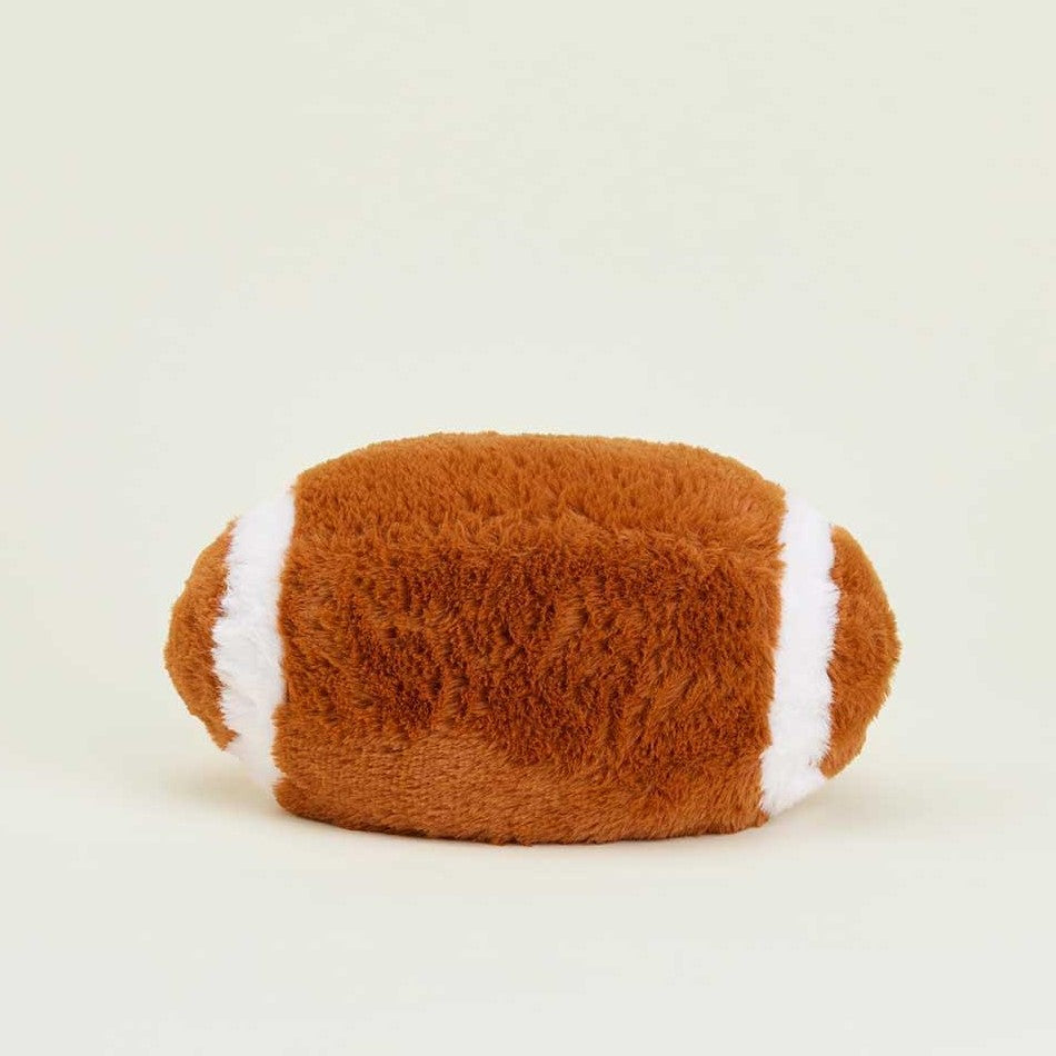 Soft, plush football-shaped pillow with white stripes.