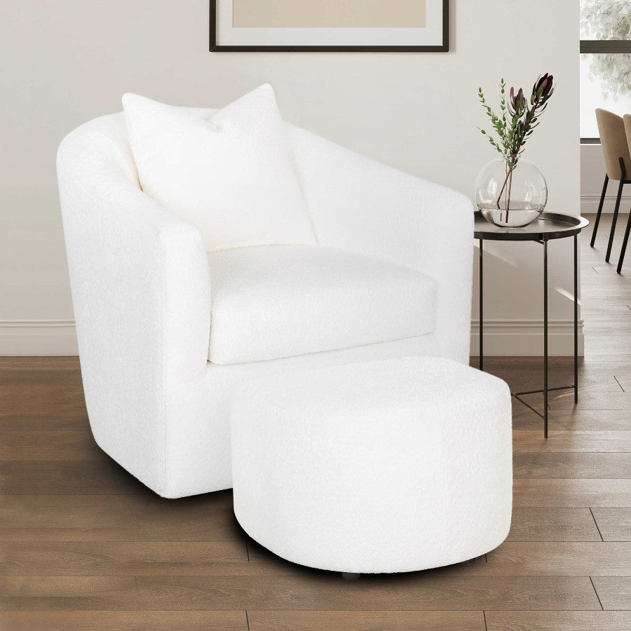 White armchair with ottoman and side table in a bright room.