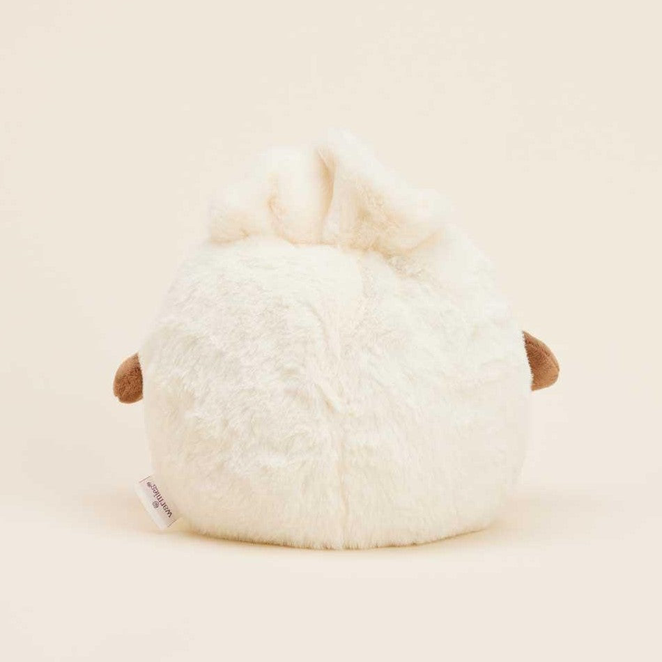 Fluffy round plush toy with bunny ears and small brown details.