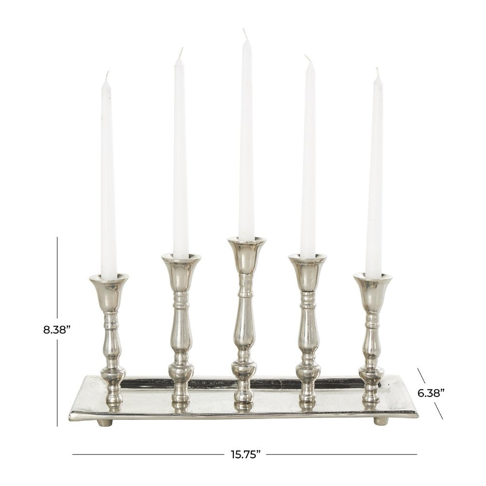 Silver candelabra with five tall white candles and measurements.