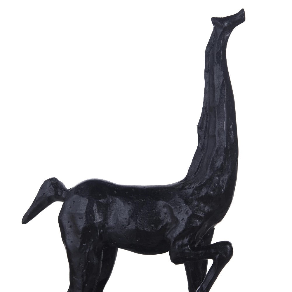 Abstract black sculpture with elongated neck and animal form.