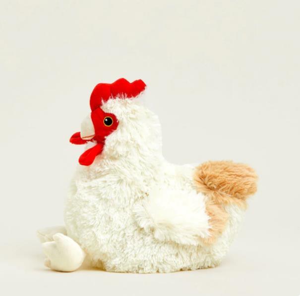 Fluffy stuffed chicken with red comb on a plain background.