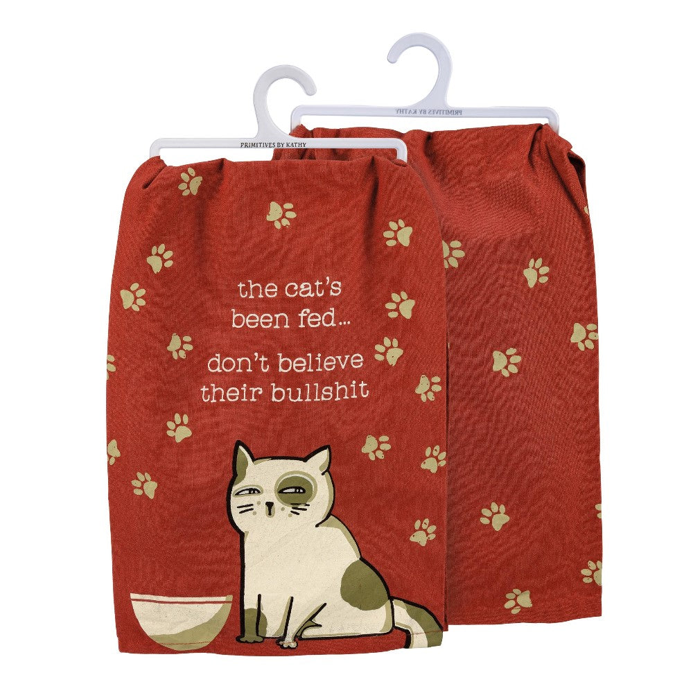 Cat towel with text about feeding and paw prints, featuring a cartoon cat.