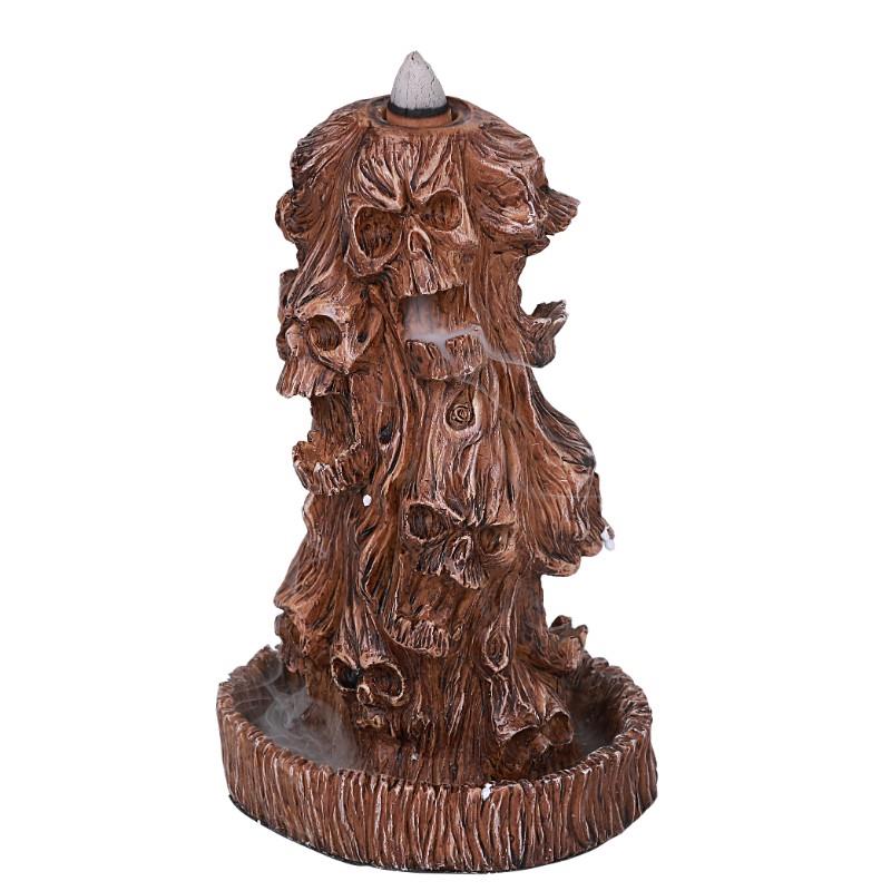 Brown cone incense burner with skull designs.