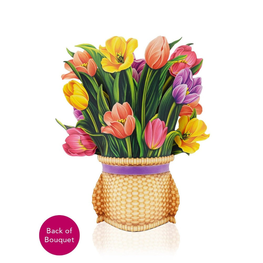 Colorful tulips in a woven basket on a white background.