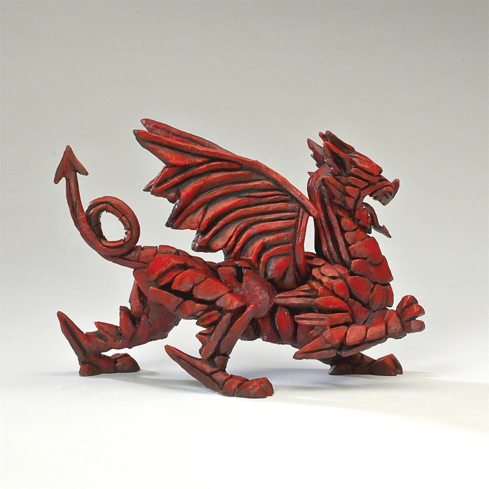 Red dragon sculpture with intricate details and a fierce pose.