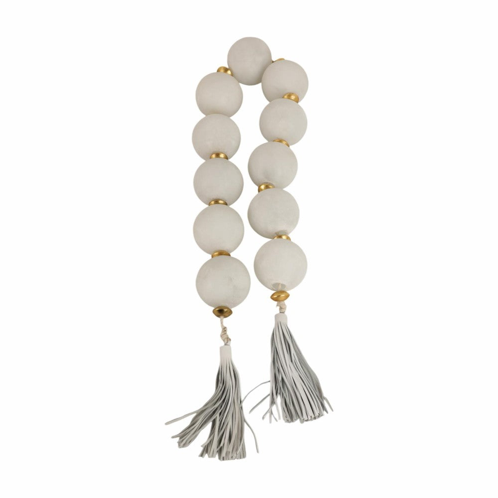 White and gold bead garland with tassels.