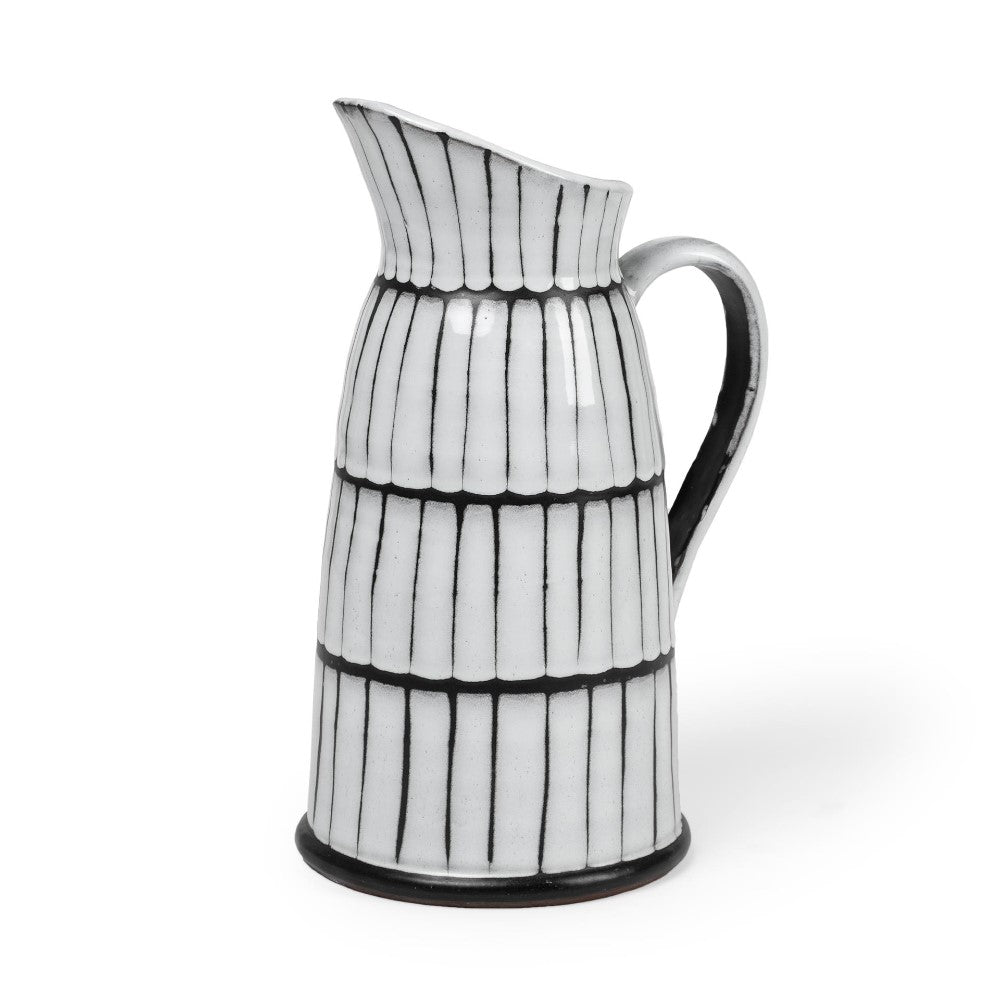 Ceramic pitcher with black striped pattern.