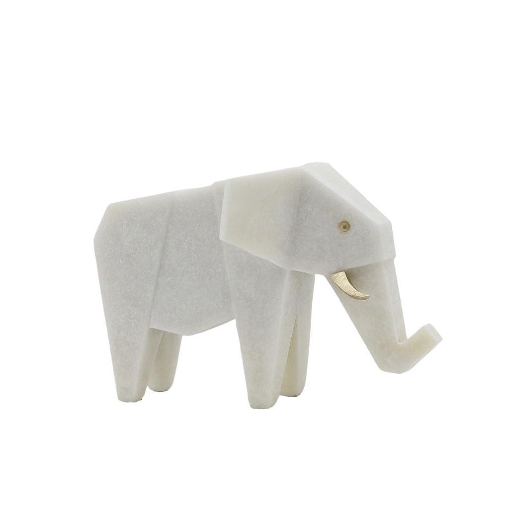 Minimalist white elephant sculpture with a gold tusk.