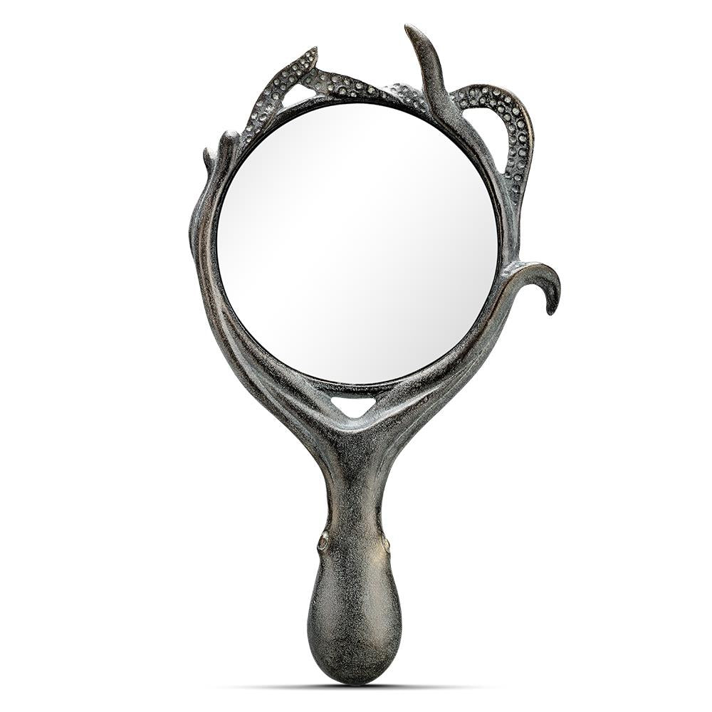 Ornate hand mirror with an artistic tentacle design.