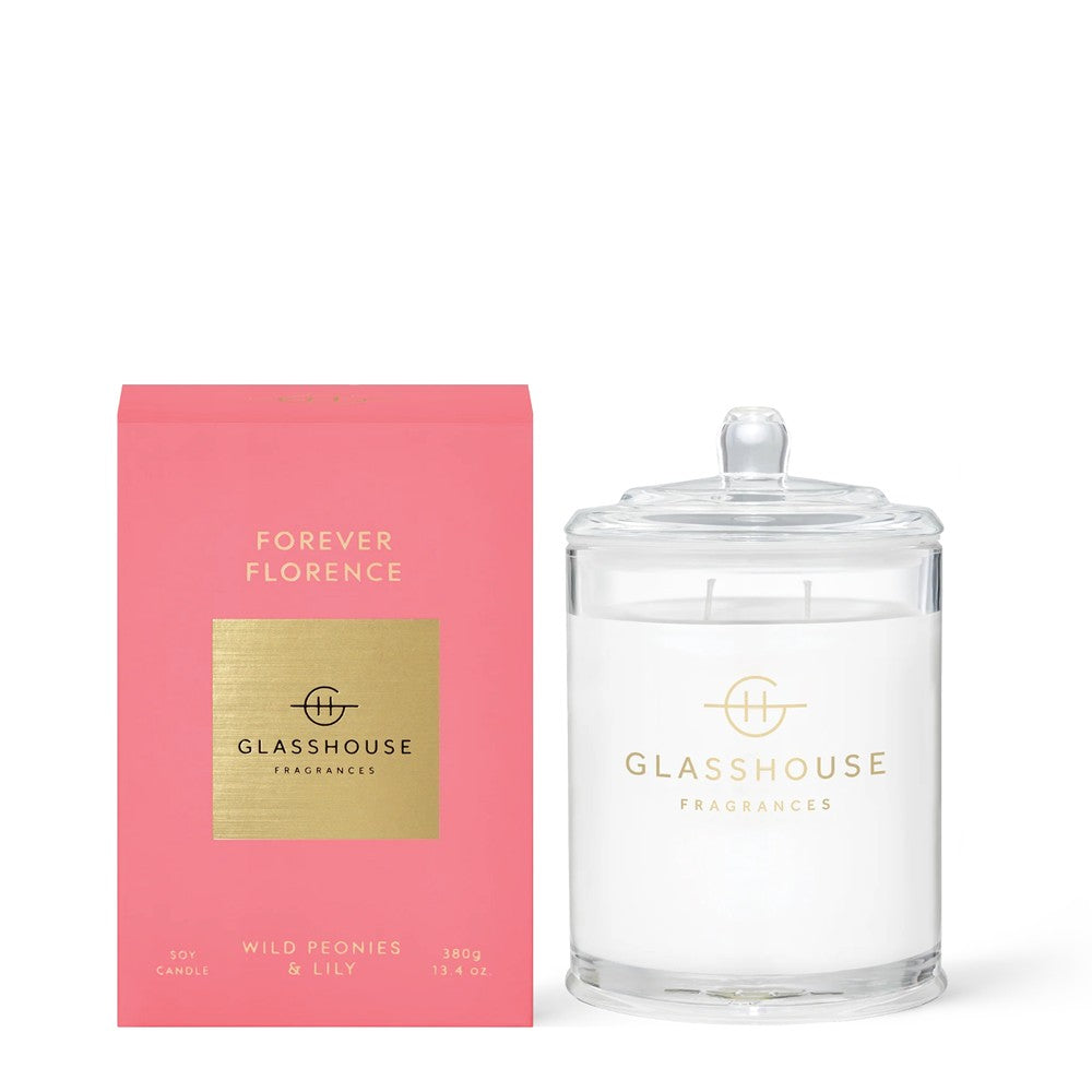 Glass candle jar beside a pink "Forever Florence" box.