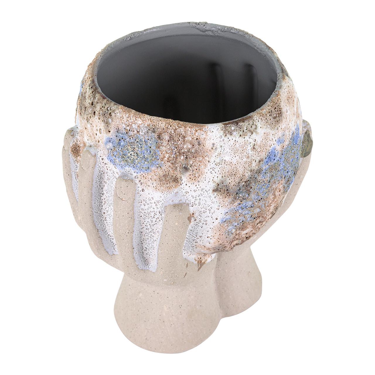 Artistic hands-shaped ceramic bowl with speckled glaze.