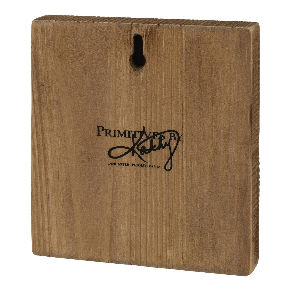 Wooden square sign with hanging slot, "Primitives by Kathy."