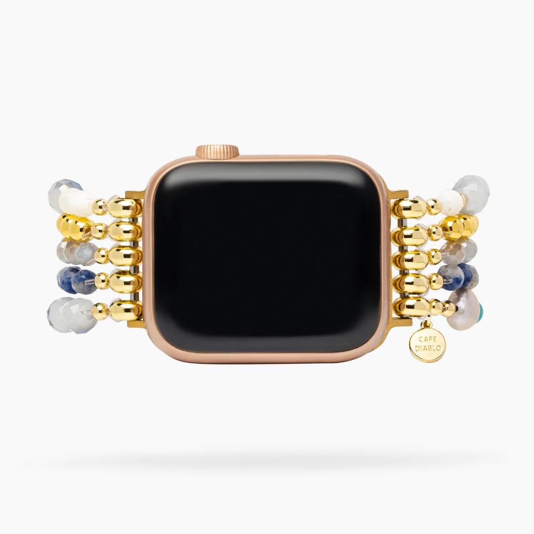Smartwatch with a beaded gold and gemstone band.