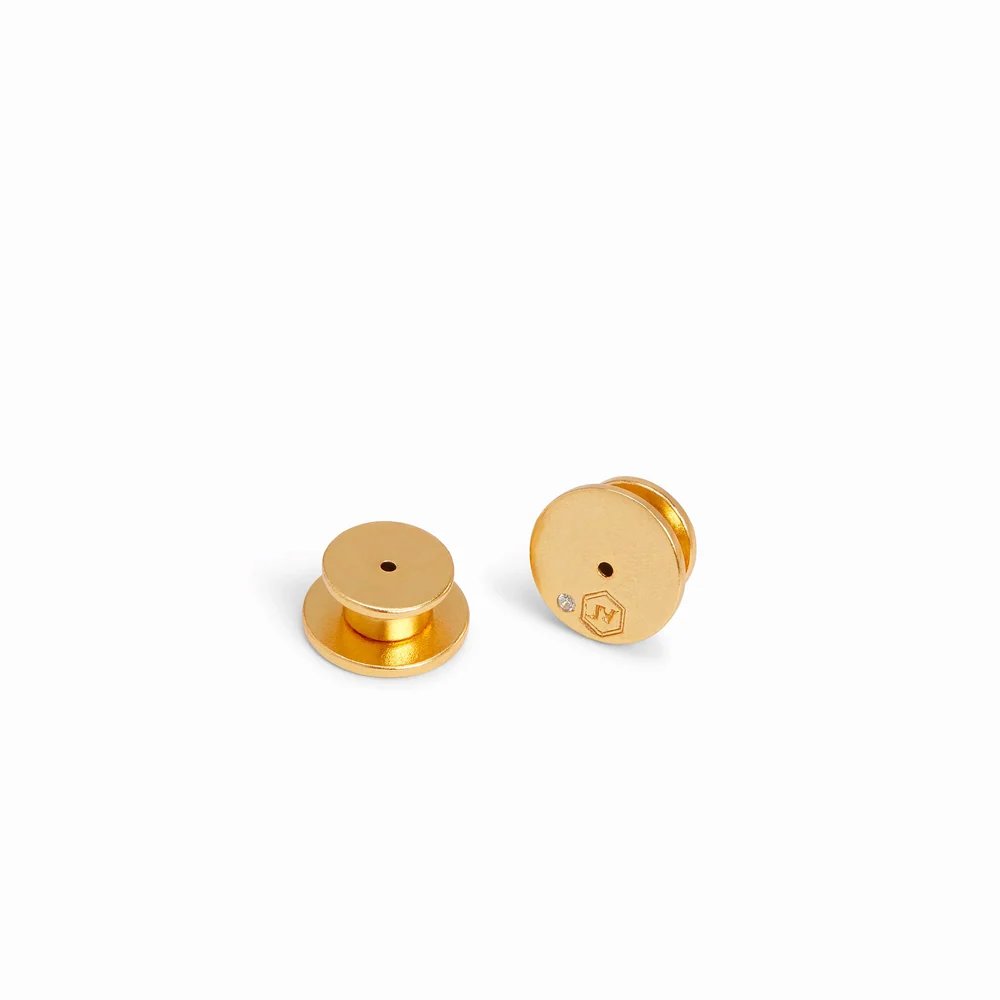 Two small gold-toned metal components with central holes, shown on a white background.