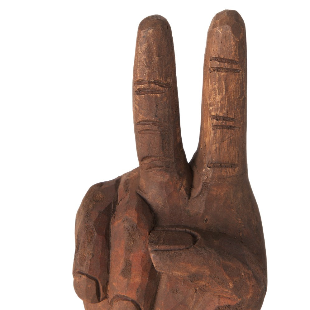 Wooden hand sculpture showing a peace sign gesture.