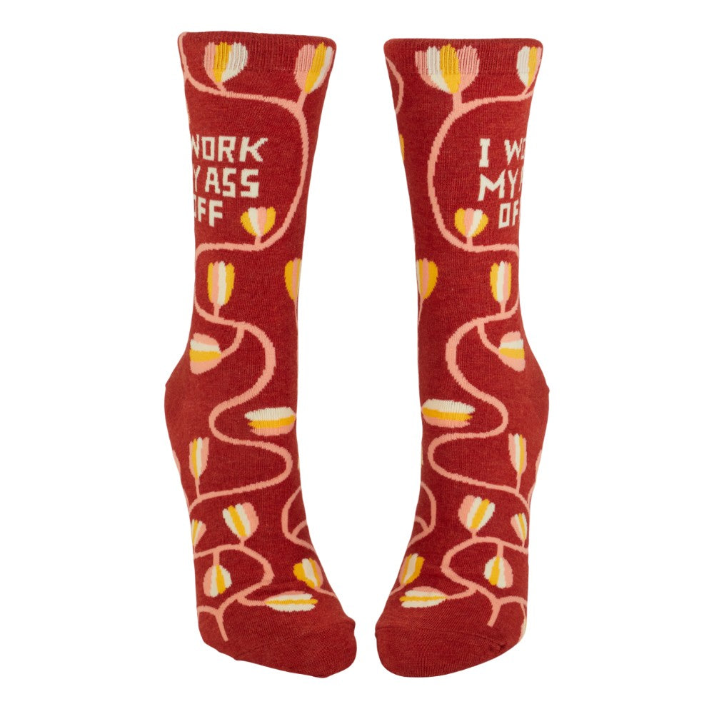 Red socks with floral patterns and "I work my ass off" text.