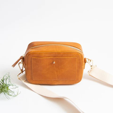 Tan rectangular bag with a front pocket and a beige strap placed on a white background.