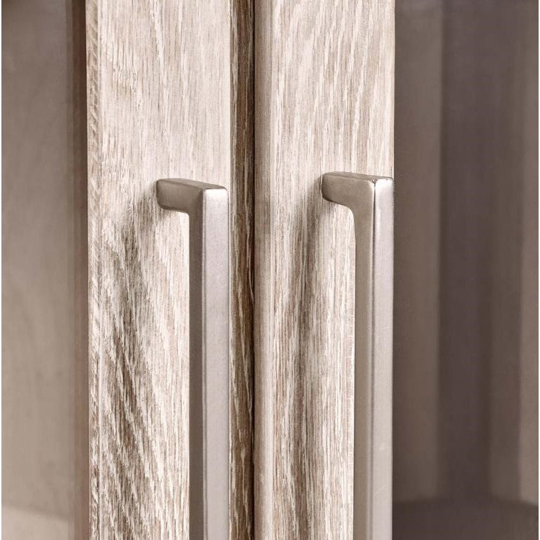 Close-up of wooden cabinet with sleek metal handles.