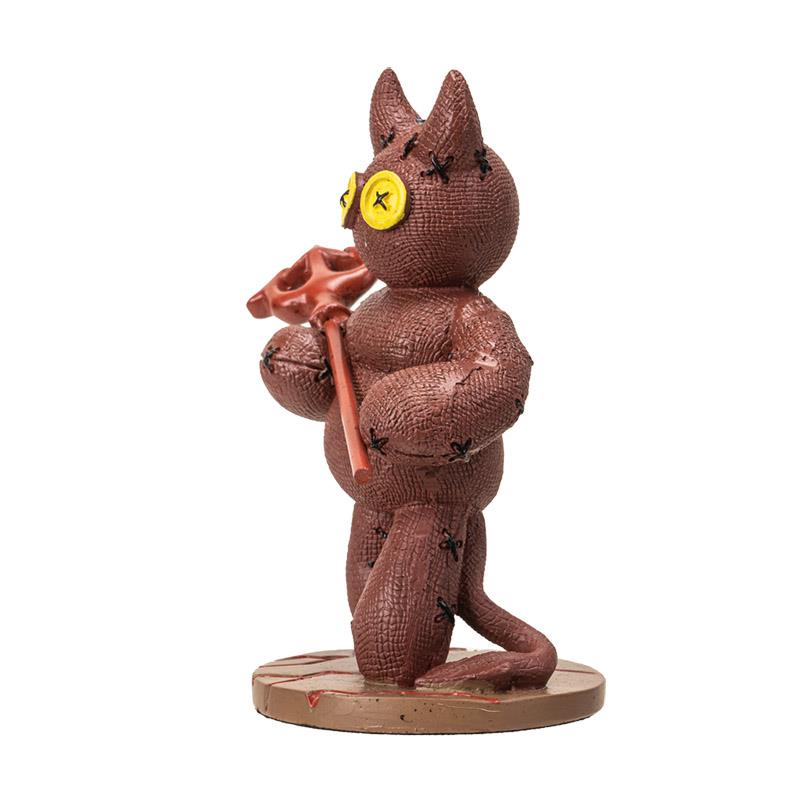Brown stitched cat toy with yellow button eyes and a staff.