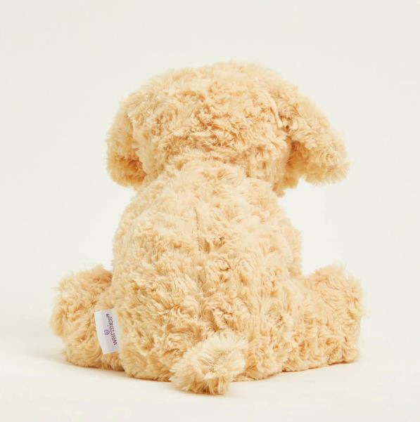 Fluffy cream teddy bear sitting with its back turned.