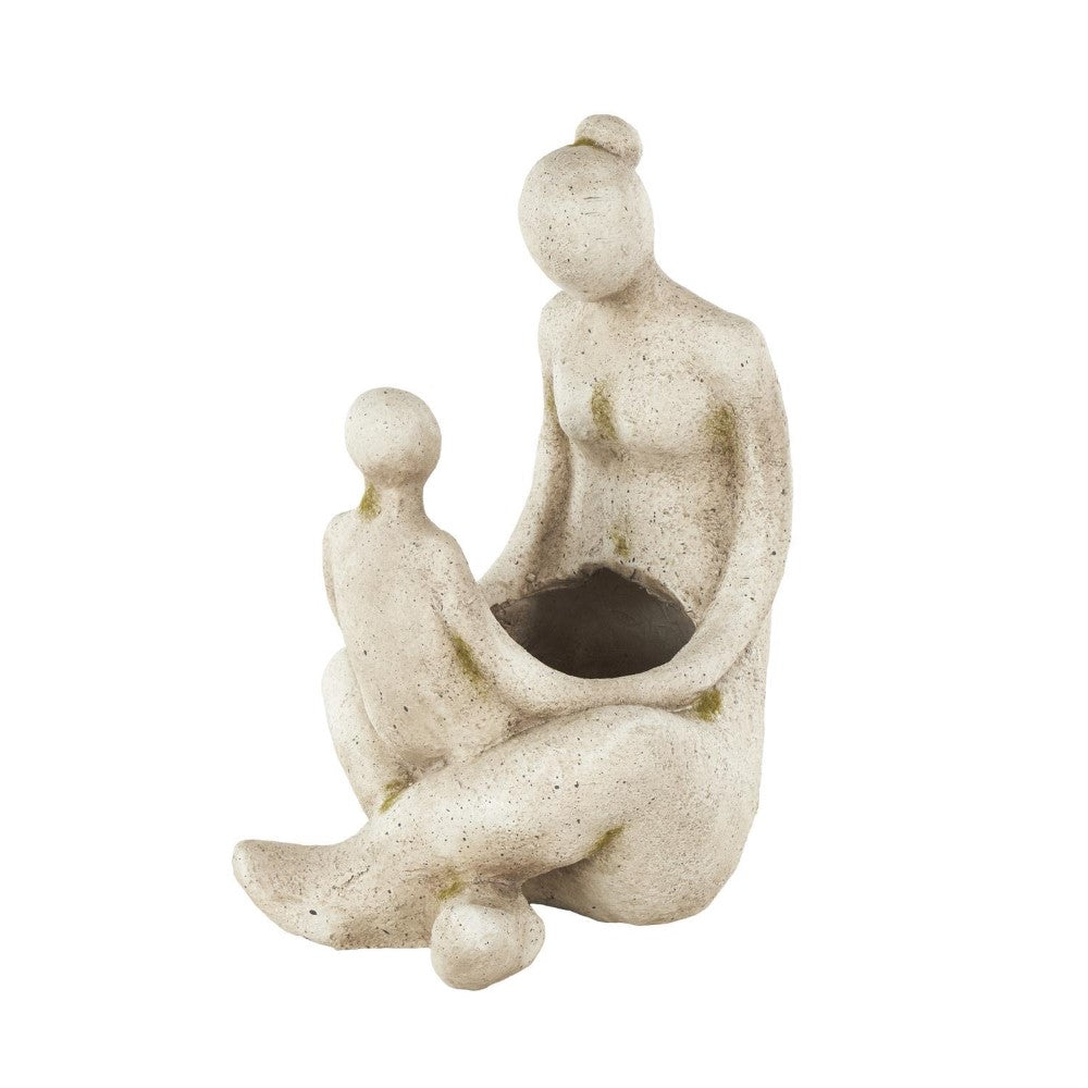 Abstract sculpture of two faceless figures sitting together.