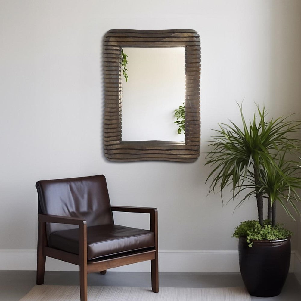 Chair, mirror, and plant in a minimalist room.