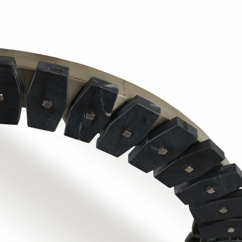 Close-up of an excavator bucket with black teeth.