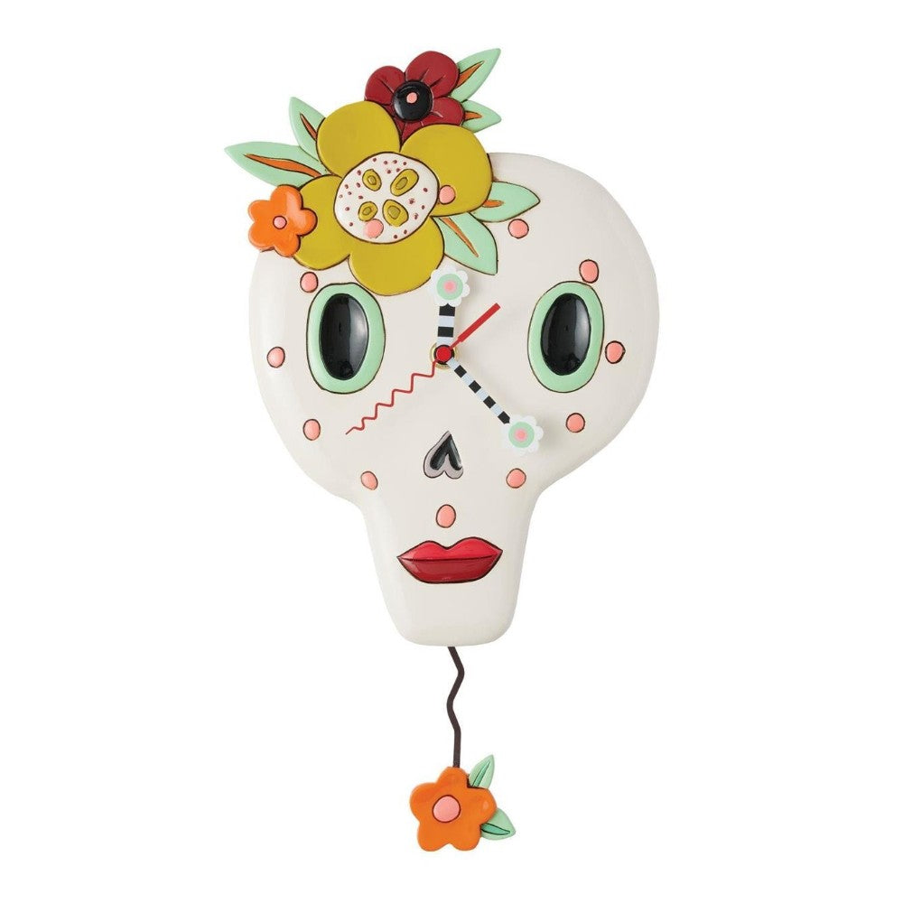 Skull-shaped clock with colorful flower design.