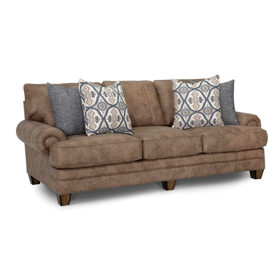 Brown sofa with patterned and textured pillows.