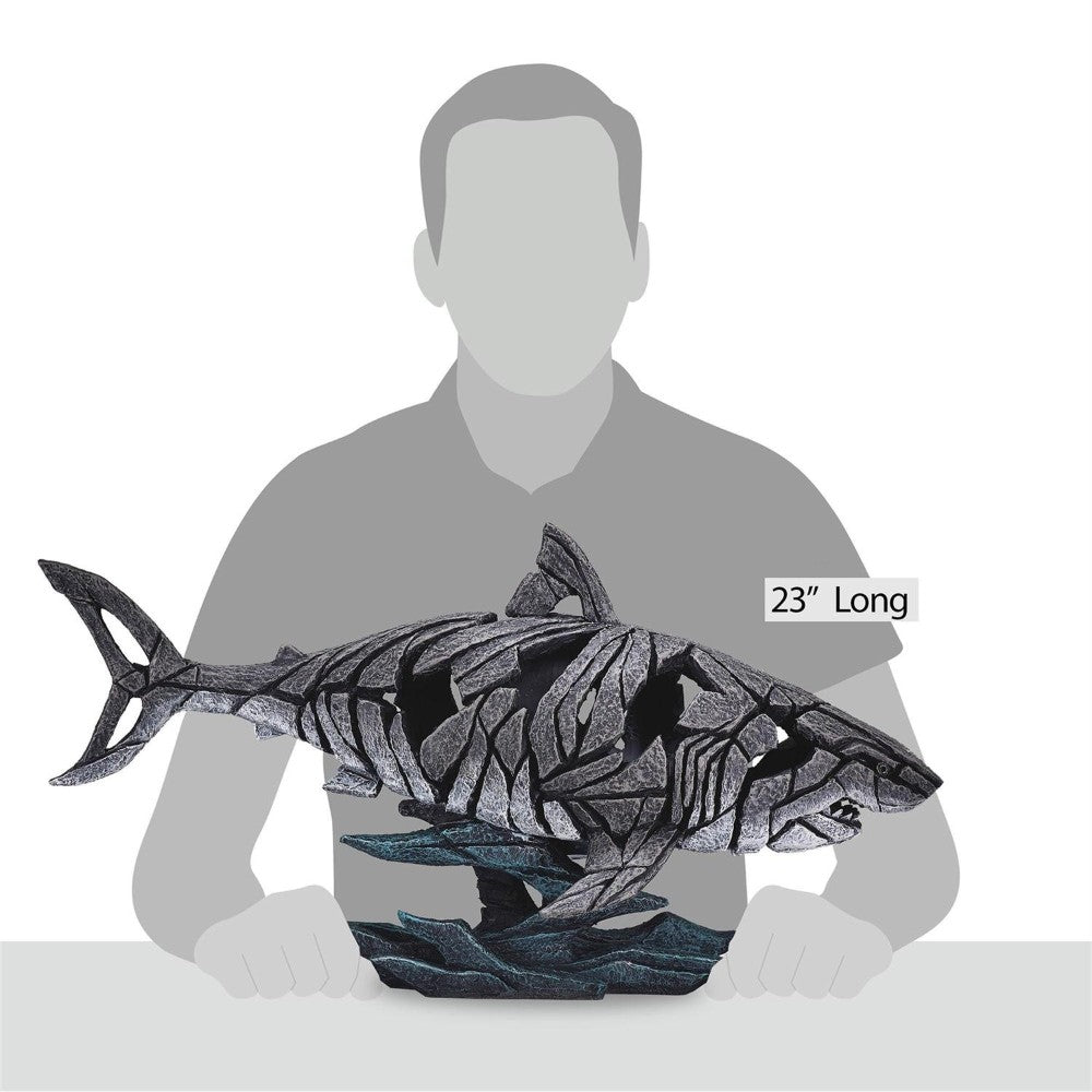 Silhouette with a 23" sculpted shark artwork on a desk.